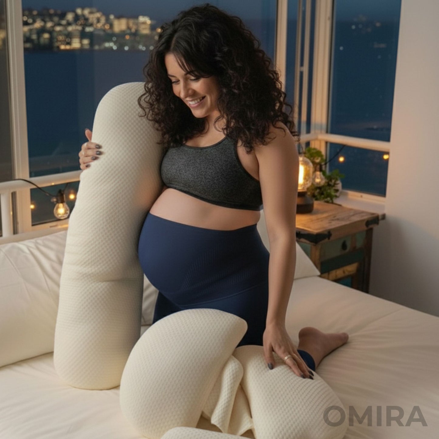 Woman using a white pregnancy pillow on a bed, designed for comfort and support.