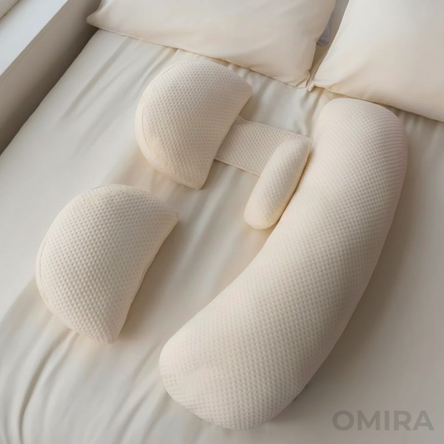 Adjustable white pregnancy pillow with detachable parts designed for belly, back, and leg support.